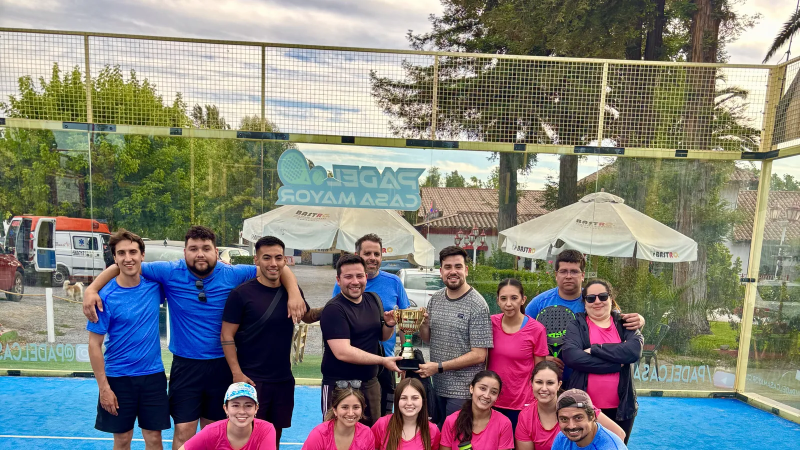 Equipo corporativo celebrando un torneo de pádel con trofeo en Padel Casa Mayor